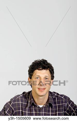 Studio shot of man, looking at camera View Large Photo Image Stock Photo - Studio shot of man, looking at camera. Fotosearch