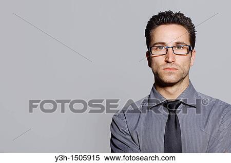 Studio shot of man, looking at camera View Large Photo Image Stock Photography - Studio shot of man, looking at camera. Fotosearch