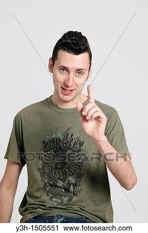 Studio shot of man, raising his finger View Large Photo Image Stock Image - Studio shot of man, raising his finger. Fotosearch