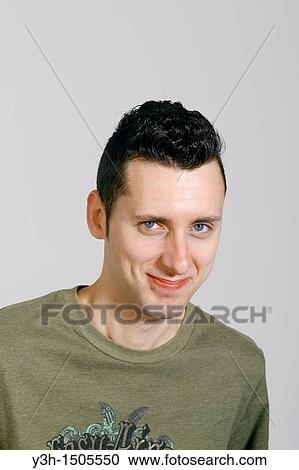 Stock Image - Studio shot of man, smiling. Fotosearch