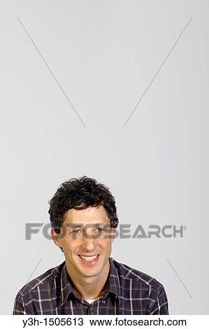 Stock Image - Studio shot of man, smiling. Fotosearch