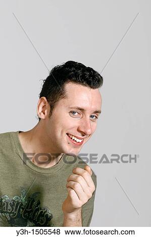 Studio shot of man, smiling View Large Photo Image Stock Photo - Studio shot of man, smiling. Fotosearch