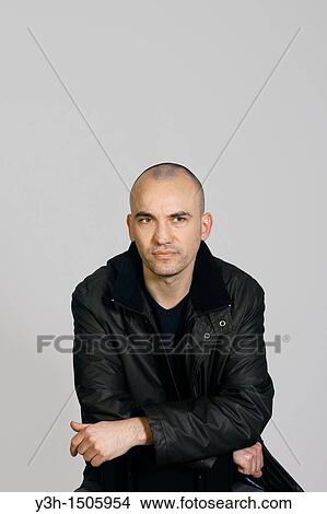Picture - Studio shot of man with shaved head. Fotosearch