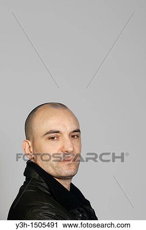 Studio shot of man with shaved head View Large Photo Image Stock Image - Studio shot of man with shaved head. Fotosearch