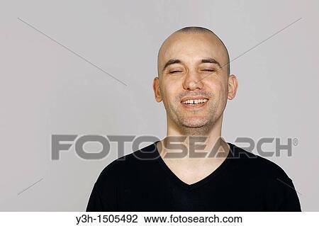 Studio shot of man with shaved head, smiling View Large Photo Image Stock Image - Studio shot of man with shaved head, smiling. Fotosearch