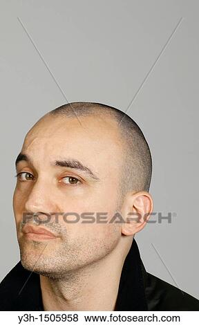 Studio shot of man with shaved head View Large Photo Image Stock Photo - Studio shot of man with shaved head. Fotosearch