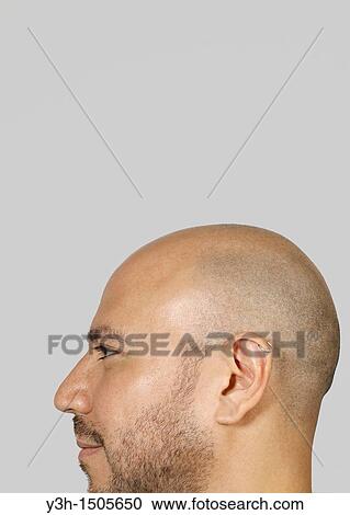Stock Image - Studio shot of Mexican man, profile. Fotosearch