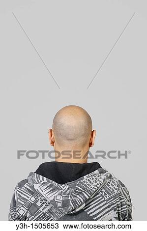 Stock Image - Studio shot of Mexican man, rear view. Fotosearch