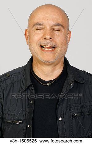 Stock Photography - Studio shot of senior man, closed eyes. Fotosearch