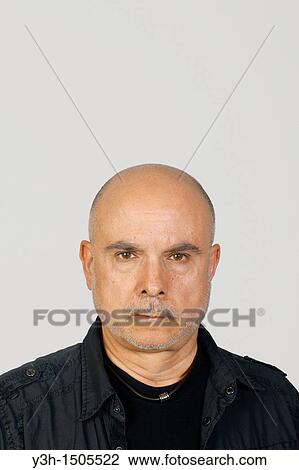 Stock Image - Studio shot of senior man, looking at camera. Fotosearch