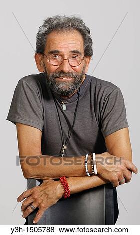 Stock Photo - Studio shot of senior man, looking at camera. Fotosearch