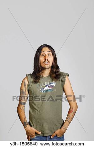 Studio shot of tattooed man View Large Photo Image Stock Image - Studio shot of tattooed man. Fotosearch