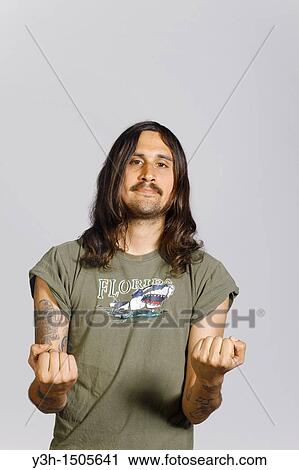 Stock Image - Studio shot of tattooed man. Fotosearch