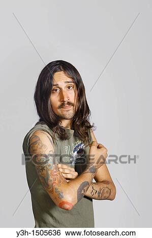 Studio shot of tattooed man View Large Photo Image Stock Photograph - Studio shot of tattooed man. Fotosearch