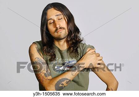 Studio shot of tattooed man View Large Photo Image Stock Photography - Studio shot of tattooed man. Fotosearch