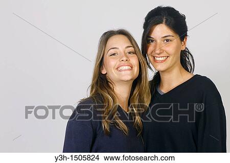 Studio shot of two young women, smiling View Large Photo Image Picture - Studio shot of two young women, smiling. Fotosearch
