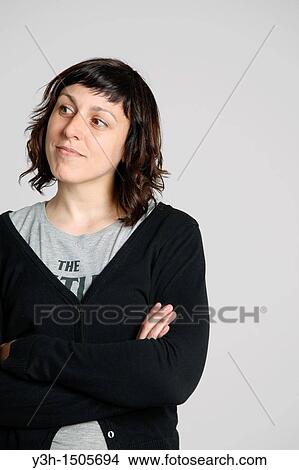 Studio shot of woman, arms crossed View Large Photo Image Picture - Studio shot of woman, arms crossed. Fotosearch