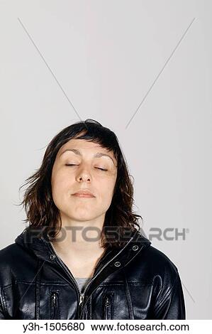 Studio shot of woman, eyes closed View Large Photo Image Stock Image - Studio shot of woman, eyes closed. Fotosearch