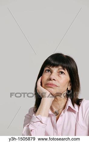 Studio shot of woman, hand of chin View Large Photo Image Stock Photo - Studio shot of woman, hand of chin. Fotosearch