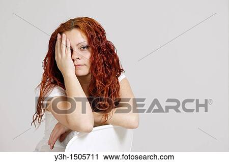Stock Image - Studio shot of woman, looking at camera. Fotosearch