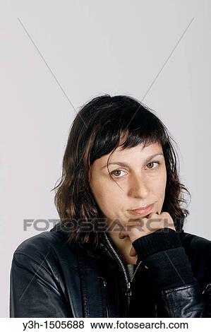 Studio shot of woman, looking at camera View Large Photo Image Stock Photo - Studio shot of woman, looking at camera. Fotosearch
