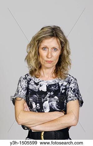 Stock Photo - Studio shot of woman, serious. Fotosearch