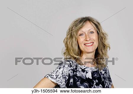 Picture - Studio shot of woman, smiling. Fotosearch