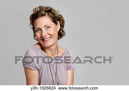 Studio shot of woman, smiling View Large Photo Image Picture - Studio shot of woman, smiling. Fotosearch