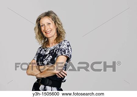 Stock Image - Studio shot of woman, smiling. Fotosearch
