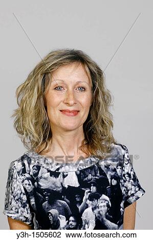 Stock Image - Studio shot of woman, smiling. Fotosearch