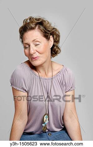 Studio shot of woman, smiling View Large Photo Image Stock Image - Studio shot of woman, smiling. Fotosearch