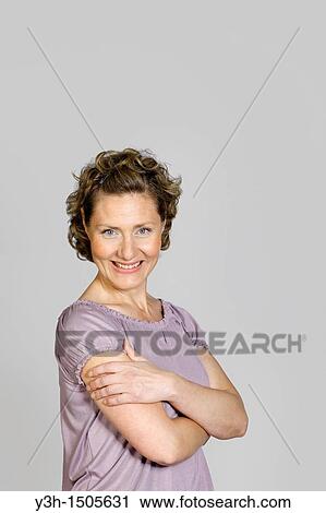 Studio shot of woman, smiling View Large Photo Image Stock Image - Studio shot of woman, smiling. Fotosearch