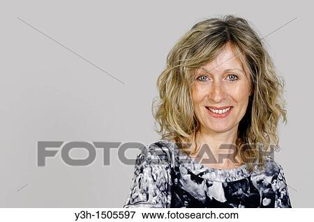Stock Photo - Studio shot of woman, smiling. Fotosearch