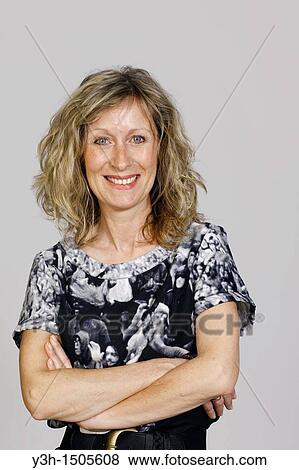 Stock Photo - Studio shot of woman, smiling. Fotosearch