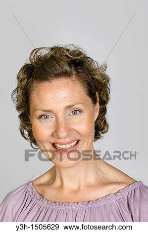 Stock Photo - Studio shot of woman, smiling. Fotosearch