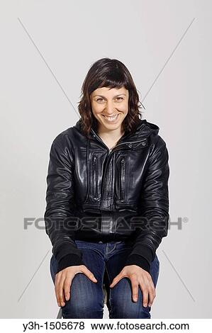Stock Photo - Studio shot of woman, smiling. Fotosearch