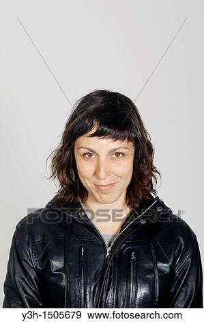 Stock Photo - Studio shot of woman, smiling. Fotosearch