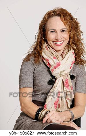 Studio shot of woman, smiling View Large Photo Image Stock Photo - Studio shot of woman, smiling. Fotosearch