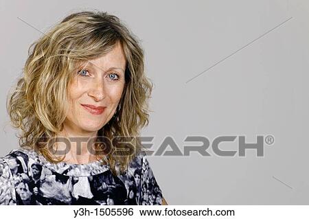 Studio shot of woman, smiling View Large Photo Image Stock Photograph - Studio shot of woman, smiling. Fotosearch