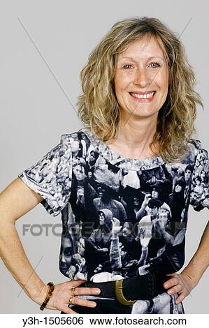 Stock Photograph - Studio shot of woman, smiling. Fotosearch