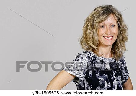 Stock Photography - Studio shot of woman, smiling. Fotosearch