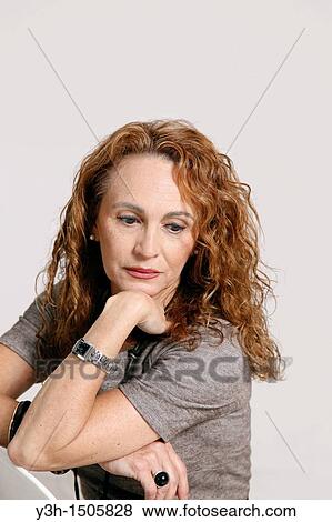 Stock Photo - Studio shot of woman, thoughtful. Fotosearch