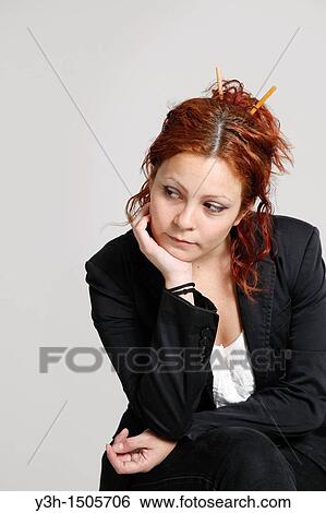 Stock Photograph - Studio shot of woman, thoughtful. Fotosearch