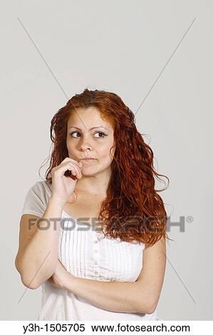 Studio shot of woman, thoughtful View Large Photo Image Stock Photography - Studio shot of woman, thoughtful. Fotosearch