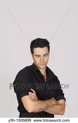 Studio shot of young Brazilian man, sad View Large Photo Image Stock Photo - Studio shot of young Brazilian man, sad. Fotosearch