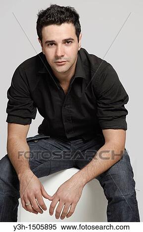 Stock Photography - Studio shot of young Brazilian man, looking at camera. Fotosearch