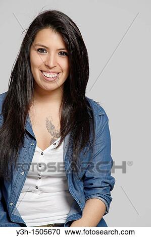 Stock Image - Studio shot of young Chilean woman, smiling. Fotosearch