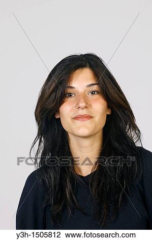 Stock Image - Studio shot of young girl, looking at camera. Fotosearch