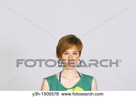 Stock Photo - Studio shot of young girl, looking at camera. Fotosearch