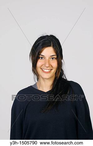 Stock Image - Studio shot of young girl, smiling. Fotosearch